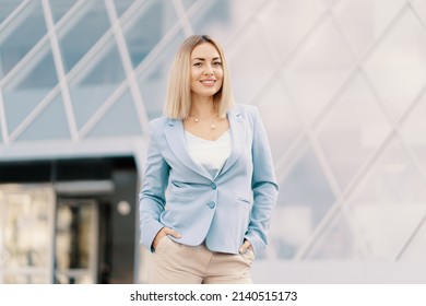 Successful Business Woman In Blue Suit. Beautiful Young Female Executive In An Urban Setting Near Office Building