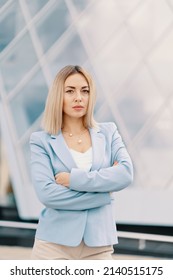 Successful Business Woman In Blue Suit. Beautiful Young Female Executive In An Urban Setting Near Office Building