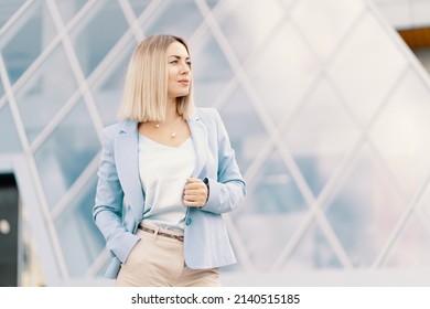 Successful Business Woman In Blue Suit. Beautiful Young Female Executive In An Urban Setting Near Office Building