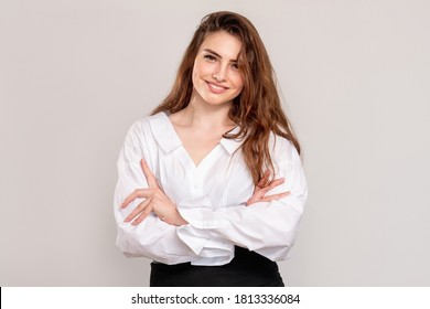 Successful Business Woman. Female Leadership. Portrait Of Smart Ambitious Lady In White Shirt Standing With Crossed Arms Smiling Isolated On Light Copy Space Background. Personal Growth.