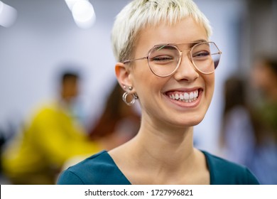 Successful business woman in modern office enjoying. Close up face of creative stylish woman smiling and looking at camera. Portrait of trendy university student laughing with classmates working. - Shutterstock ID 1727996821