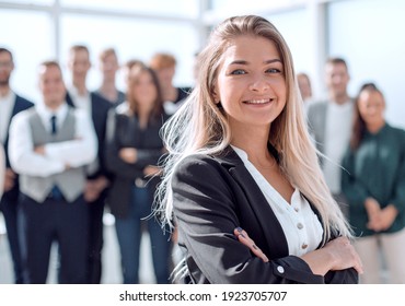 successful business woman on the background of a group of young employees. - Shutterstock ID 1923705707