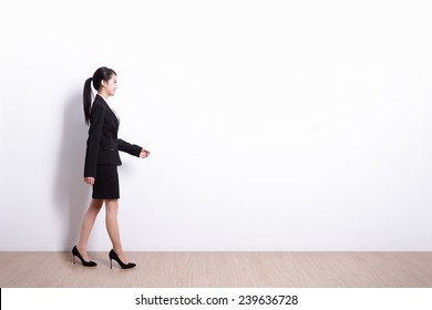 Successful Business Woman Walking With White Wall Background, Great For Your Design Or Text, Asian