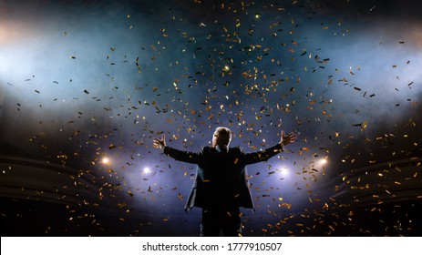 Successful businessman with arms up celebrating his victory. Celebrating success. Low angle view of excited young businessman keeping arms raised and expressing positivity while stands on the stage - Shutterstock ID 1777910507
