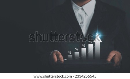 Successful businessman calculating investment income on a tablet with percentage symbol and up arrow, Interest rates continue to increase, return on stocks and mutual funds, for retirement planning.