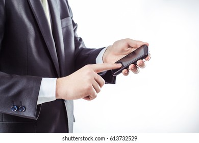 successful businessman clicks on the smartphone screen.