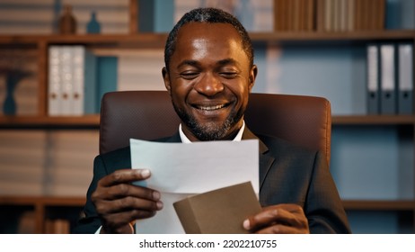 Successful Businessman Sits In Office Opening Paper Envelope Reading Letter With Good News Received Bank Loan Approval Profitable Proposition Happy Man Gets Promotion Career Advance Great Opportunity