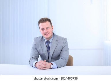 Successful Businessman Sitting Behind A Desk