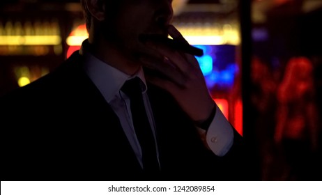 Successful Businessman Smoking Cigar, Enjoying Evening In Elite Strip Club