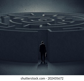 Successful businessman standing near the entrance of labyrinth - Shutterstock ID 202435672