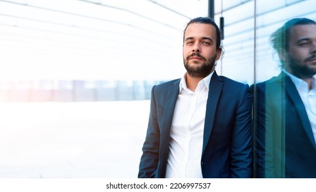 Successful Businessman In Suit With Beard Standing Near Office Building Confidently Looking At Camera Lean Wall. Hispanic Male Business Person Portrait. Web Banner, Free Space. Modern Business People