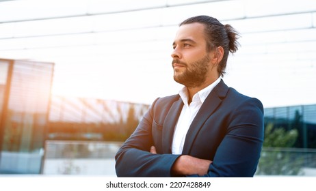 Successful Businessman Suit With Beard Standing In Front Of Office Glass Building Arm Crossed Confidently Looking Away. Hispanic Male Business Person Side View Portrait. Web Banner, Free Space