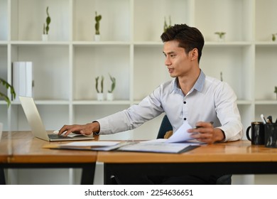 Successful businessman using laptop, working on financial and marketing project at contemporary office - Shutterstock ID 2254636651