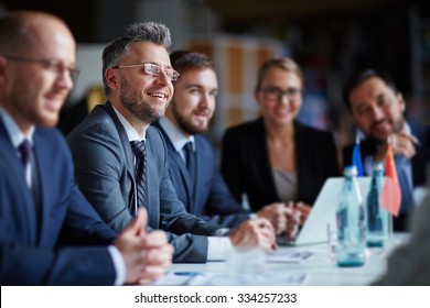 Successful businesspeople sitting at conference or seminar during lecture