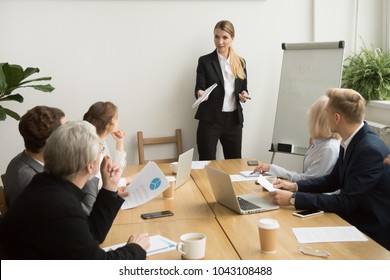 Successful businesswoman giving presentation to business team, female ceo leader coaching teaching on corporate training, woman boss talking planning explaining answering questions at group meeting