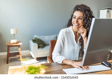 Successful Businesswoman Standing In Creative Office And Looking At Camera. Young Latin Woman Entrepreneur In A Coworking Space Smiling. Portrait Of Beautiful Business Woman 