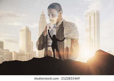 Successful Businesswoman And Thoughtful Businessman On Mountain Top. Leadership And Future Concept. Abstract City Background With Sunlight And Silhoutte. Double Exposure