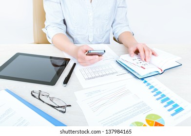 Successful caucasian businesswoman sitting at desk in casual clothes and planning her working day in the office - Powered by Shutterstock