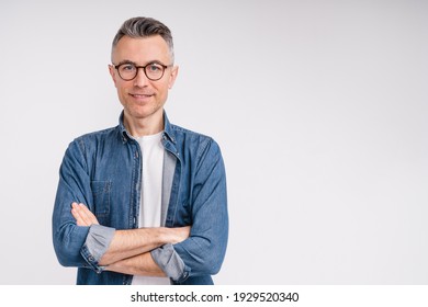 Successful caucasian middle-aged man in casual outfit with arms crossed isolated over white background