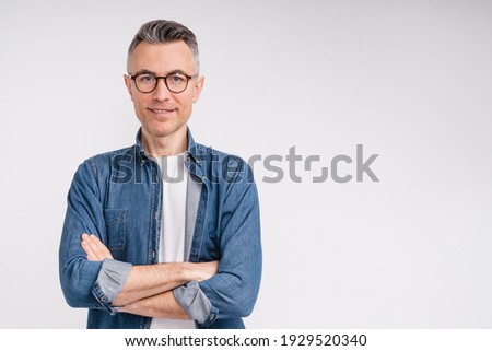 Successful caucasian middle-aged man in casual outfit with arms crossed isolated over white background