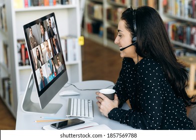 Successful Caucasian Woman Manager Or Call Center Worker In Headphones Communicates Online By Video Conference With Her Colleagues Or Clients About Important Working Moments