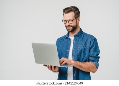 Successful caucasian young man student freelancer using laptop  watching webinars  working remotely  e  learning e  commerce online isolated in white background