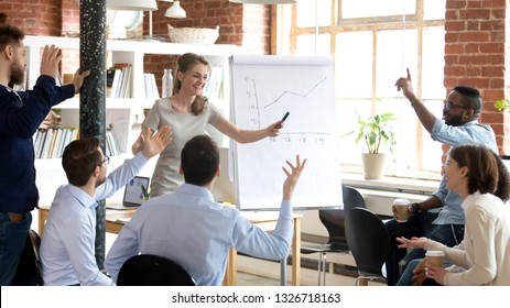 Successful cheerful businesswoman company head presenting new project to multi-ethnic young employees, diverse people voting raising hands or business coach giving presentation to clients in boardroom - Powered by Shutterstock