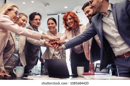 Successful colleagues at a meeting in modern office,they are putting their hands together. - Shutterstock ID 1085684420