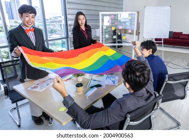 Successful Company With Happy Workers Group Of Asian Business People With Diverse Genders (LGBT) Celebrate LGBT Freedom And Support With LGBT Flag In The Meeting Room At Office