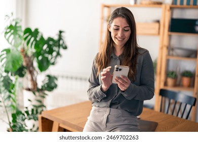 Successful confident woman entrepreneur with mobile phone indoors. - Powered by Shutterstock