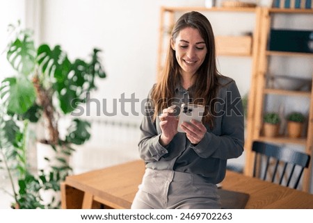 Similar – Image, Stock Photo a woman in front of a flower meadow. picking flowers