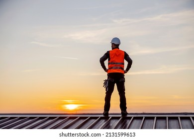 A successful construction site worker on the rooftop looking for new challenges. - Shutterstock ID 2131599613
