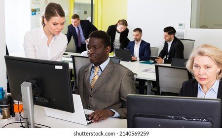 Successful Coworkers Engaged In Business Activities In Busy Open Plan Office.