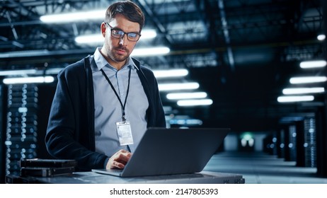 Successful Data Center IT Specialist Using Laptop Computer. Server Farm Cloud Computing Facility with System Administrator Working. Data Protection Engineering Network for Cyber Security. - Shutterstock ID 2147805393