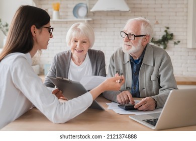 Successful deal. Lawyer financial adviser helping consulting showing contract mortgage loan credit business startup, signing documents by elderly senior old grandparents couple at home - Shutterstock ID 2121374888