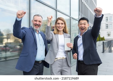 Successful Diverse Business Team, Business People Looking At Camera And Rejoicing In Success And Victory, Man And Woman Holding Hands Up Outside Office