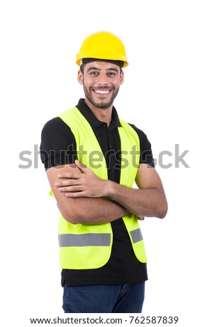 successful engineer wearing vest and yellow helmet with folded arms, isolated on white background.