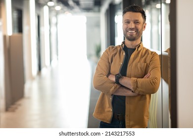 Successful Entrepreneurship. Happy Businessman Smiling To Camera Posing Crossing Hands Standing In Doorway Of Modern Office. Employment And Business Career Concept - Shutterstock ID 2143217553