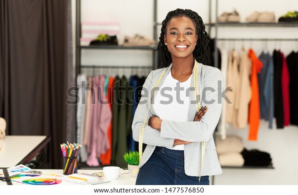 Successful Fashion
Business. Smiling Black Designer Posing In Own Dressmaking Studio
Or Boutique. Free
Space