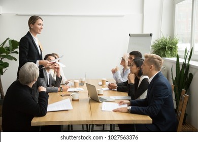 Successful Female Boss Leading Team Meeting Talking To Multiracial Employees, Woman Executive Leader Discussing Work Results Presenting Contract Report To Diverse Partners At Company Group Briefing