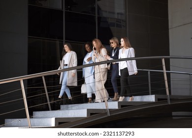 Successful female executives in formal attire walking out of office building at end of workday - Powered by Shutterstock