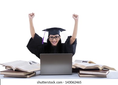 Successful Female Grad Raising Her Arms With Books And Laptop On White Background