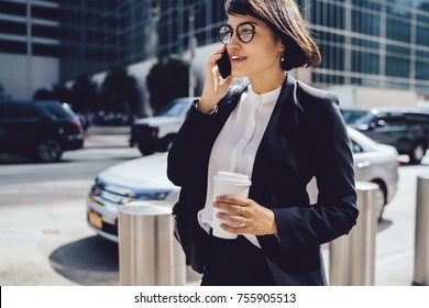 Successful Female Manager In Elegant Wear Walking On City Street And Talking On Mobile, Prosperous Businesswoman Having Phone Conversation About Work Holding Coffee To Go With Copy Space For Brand Nam