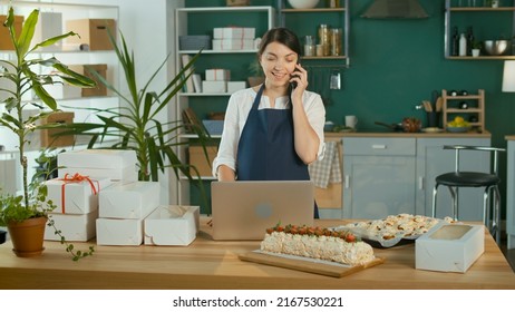 Successful Female Small Business Owner Prepares A Customer Order. Modern Designer Kitchen. Confectionery And Favorite Business. Organization Of Work In The Field Of Delivery. Startup.