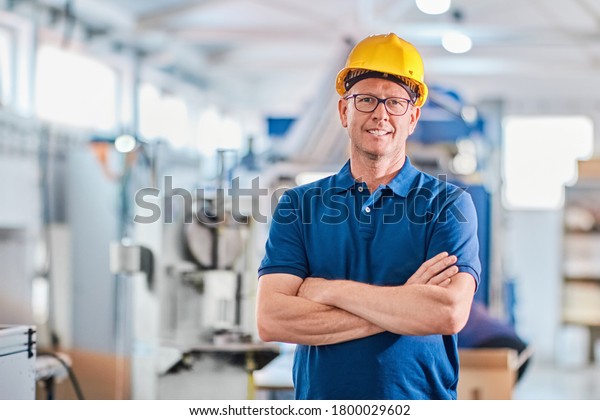Successful foreman manager working\
with data and controlling work of industrial\
machine