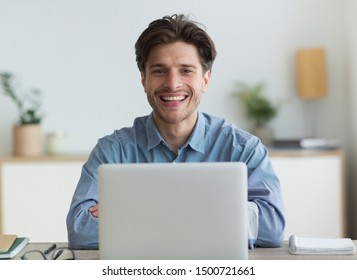 Successful Freelancer. Happy Guy Smiling At Camera Sitting At Laptop In Home Office. Selective Focus