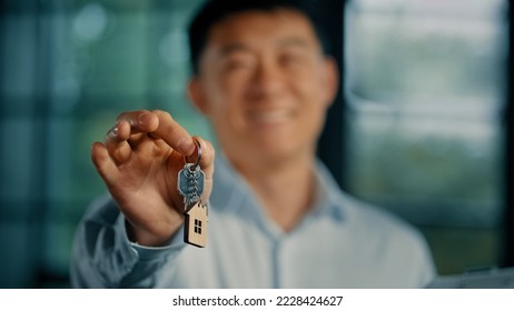 Successful happy asian man homeowner businessman realtor estate manager hold keys of modern office buy new apartment invest in realty housing mortgage lending dwelling lease ownership sale apartment - Shutterstock ID 2228424627