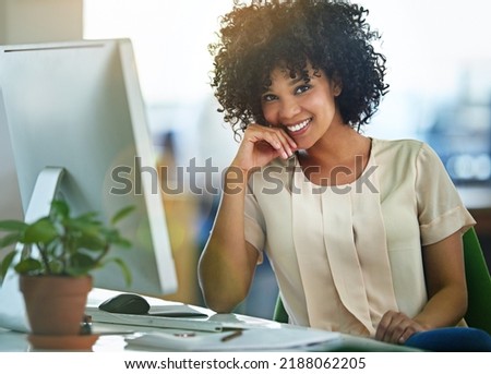 Successful, happy and confident business woman sitting at computer at desk with a positive mindset. Beautiful, healthy female entrepreneur or innovative, trustworthy leader smiling while working.