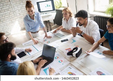 Successful happy group of people learning software engineering and business during presentation - Powered by Shutterstock