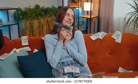 Successful Happy Rich Business Woman Girl Counting Money Cheering Up With High Profits, Lottery Game Win, Satisfied Of Wealth Income Earnings Salary, On Home Room Couch Full Of Dollar Cash Banknotes